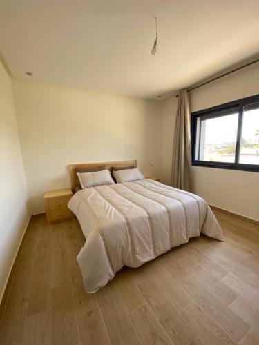 Ένα ή περισσότερα κρεβάτια σε δωμάτιο στο appartement S-oumaima 2 el jadida