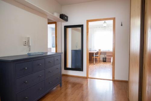 a living room with a dresser and a mirror at Sarah´s apartment Bratislava in Bratislava