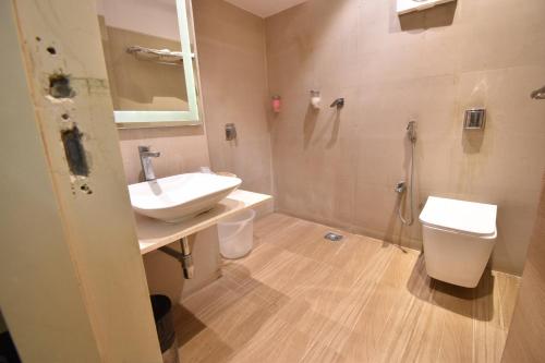 a bathroom with a sink and a toilet and a shower at Hotel Atlantic in Mumbai