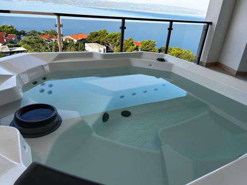 a jacuzzi tub on the balcony of a house at Ivana&Luka-superior wellnes in Brela