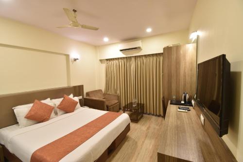 a hotel room with a bed and a television at Hotel Atlantic in Mumbai