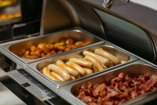 a group of trays of hot dogs and other food at Hanoi Fiesta Grand Hotel and Spa in Hanoi