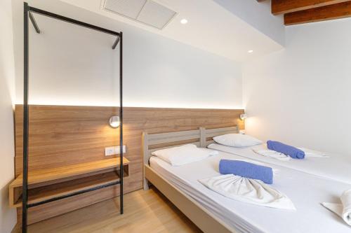a bedroom with two beds and a glass wall at Kostakis Beach in Gerani Chanion