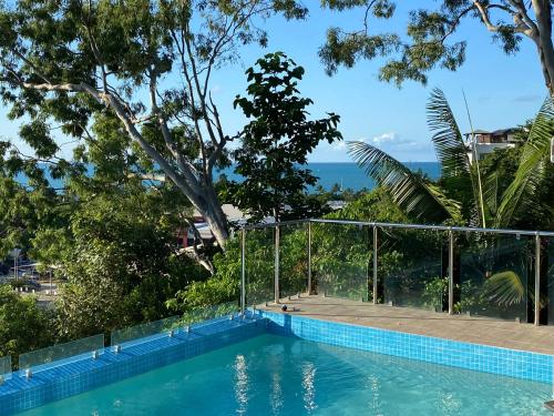 a swimming pool with a view of the trees at Fabulous 2 bedroom with private pool in Airlie Beach