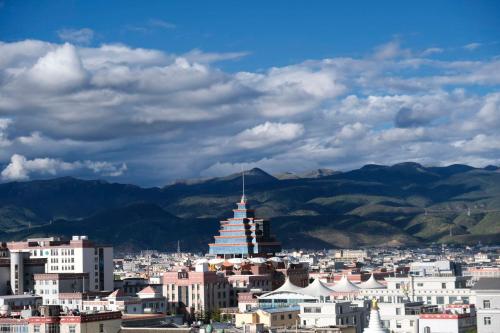 a view of a city with mountains in the background at Kevin's Trekker Inn in Shangri-La