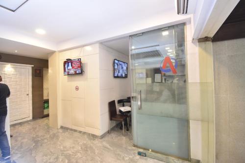 a person standing in a lobby with a glass door at Hotel Atlantic in Mumbai