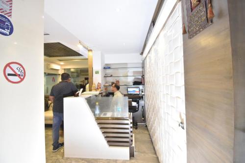 a group of people standing at a counter in a restaurant at Hotel Atlantic in Mumbai