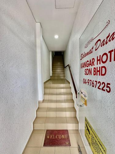 a staircase in a hotel with a sign on the wall at Kangar Hotel Sdn Bhd in Kangar