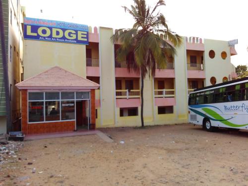 a bus parked in front of a building at Hotel Ganesh Lodge in Kanyakumari