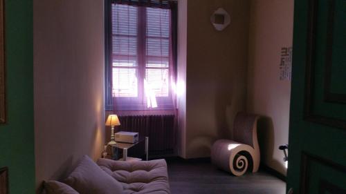 a living room with a couch and a window at La Pulce Argentata in Sestri Levante