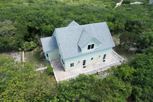 an overhead view of a house with a blue roof at Hidden Gem Exuma - KING BED master suite and central air in Georgetown