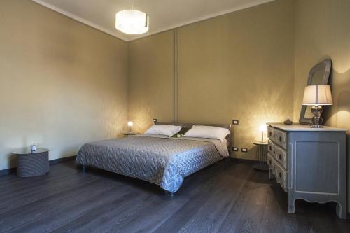 a bedroom with a bed and a dresser with a mirror at La Pulce Argentata in Sestri Levante