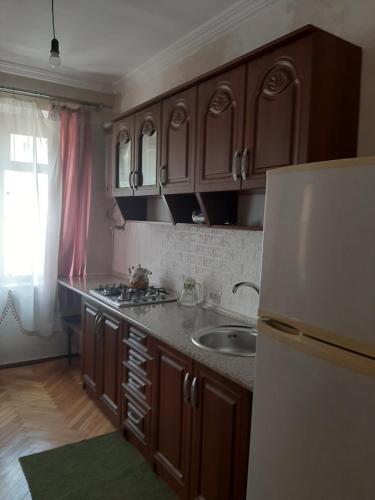 a kitchen with a sink and a refrigerator at hotel in Chiatʼura
