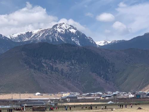 a group of people standing in front of a mountain at Kevin's Trekker Inn in Shangri-La