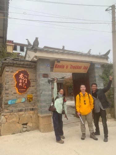 a group of people standing in front of a building at Kevin's Trekker Inn in Shangri-La