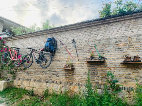 a brick wall with two bikes on it at Kevin's Trekker Inn in Shangri-La
