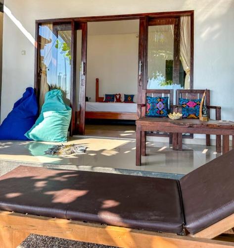 a living room with a couch and a table at Kumpul Beach in Amed