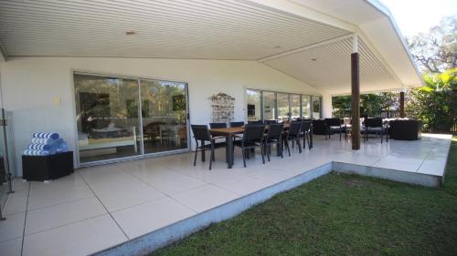 a patio with a table and chairs on it at Bather's Pavilion Holiday House in Horseshoe Bay