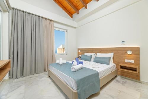a bedroom with a bed and a large window at Kostakis Beach in Gerani Chanion
