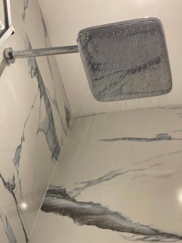 a shower head on the ceiling of a bathroom at Modern Comfort in South of Malta in Tarxien