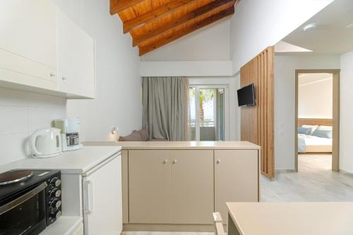 a kitchen with white cabinets and a stove top oven at Kostakis Beach in Gerani Chanion