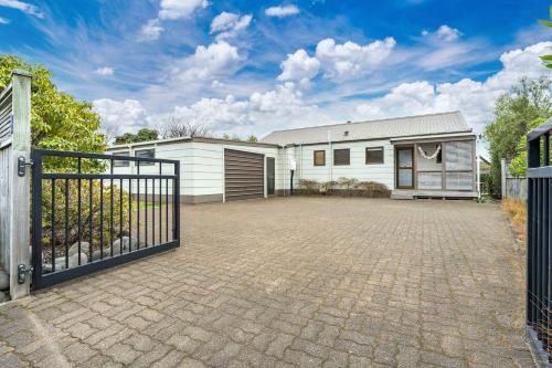 a house with a gate and a driveway at Greenhaven with wi-fi in Taupo
