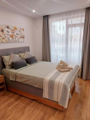 a bedroom with a large bed with a window at Toni's hidden gem in Kazanlŭk