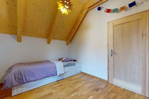 a bedroom with a bed and a wooden floor at Chata Vysoké Tatry in Stará Lesná
