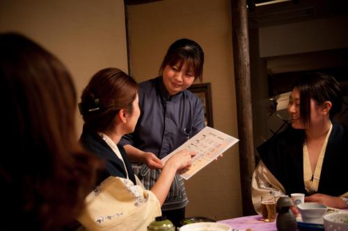 a woman holding a piece of paper in a group of people at Kounkaku in Nihommatsu