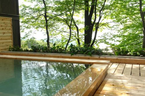 a house with a swimming pool and trees at Kounkaku in Nihommatsu