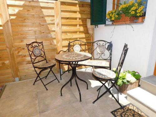 a table and chairs on a patio with a staircase at Vali's Paradise in Ptuj