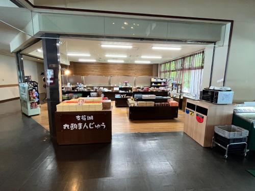 a room with a store with a counter and a room at Sapporo's Secret Onsen Sanctuary Marukoma Onsen Ryokan in Chitose