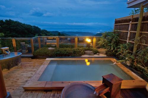 a small swimming pool on a deck with a house at Kounkaku in Nihommatsu
