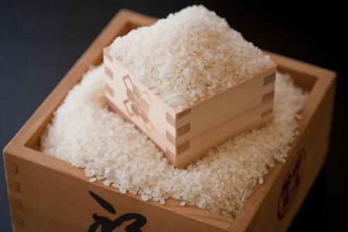 a wooden box filled with white rice at Kounkaku in Nihommatsu
