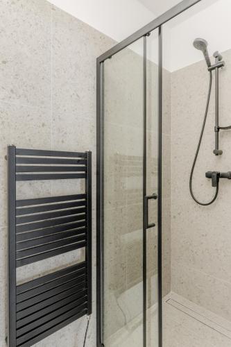 a shower with a glass door in a bathroom at BALANCE apartments in Znojmo