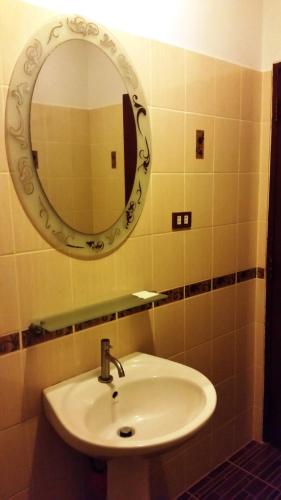 a bathroom with a sink and a mirror at Pongsin Resort in Khun Han
