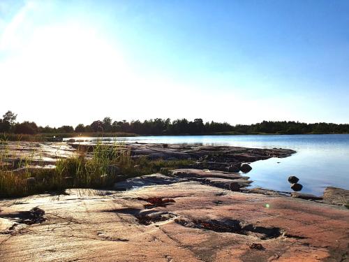 a large body of water with rocks in the water at Eckerö Camping & Stugor in Eckerö