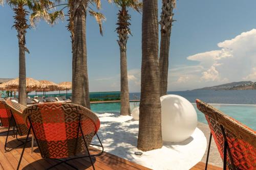 a resort with palm trees and a swimming pool at Voger Bodrum by The Sea in Yalıkavak
