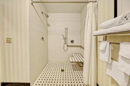 a bathroom with a shower and a shower curtain at Fairfield Inn & Suites Memphis Olive Branch in Olive Branch