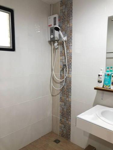 a shower in a bathroom with a sink at Maruay Living Apartment 401 (Khaosan/Chinatown/Samyot MRT) in Bangkok