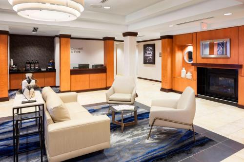 a lobby with couches and chairs and a fireplace at Fairfield by Marriott Inn & Suites Wilmington Wrightsville Beach in Wilmington