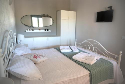 a small bedroom with a bed with a mirror at Merastri Villa in Zarós