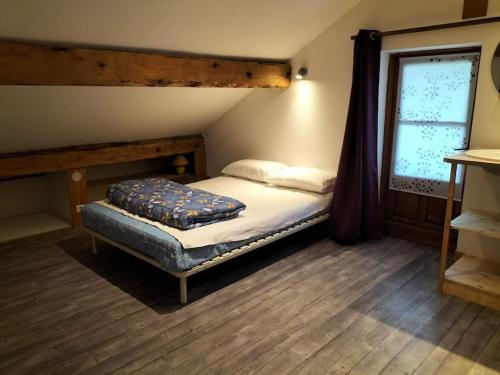 una piccola camera con letto e finestra di A découvrir Superbe Maison Calme et Lumineuse a Vallouise
