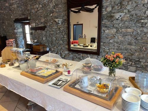 a table with a buffet of food on it at Les Magnolias in Plaisance