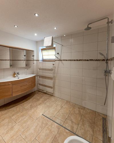a bathroom with a shower and a sink and a toilet at Chalets Lampllehen in Marktschellenberg