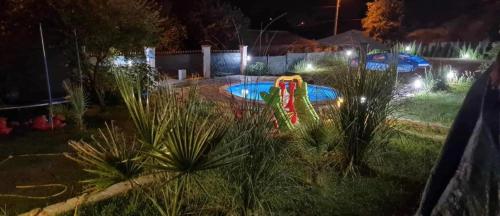 a backyard with a pool at night with lights at Sunshine villa Dzhigurovo in Sandanski