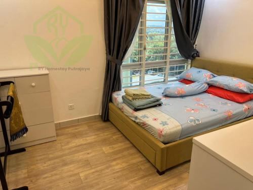a small bedroom with a bed and a window at 3R@7pax++ Spacious Space Putrajaya. in Putrajaya