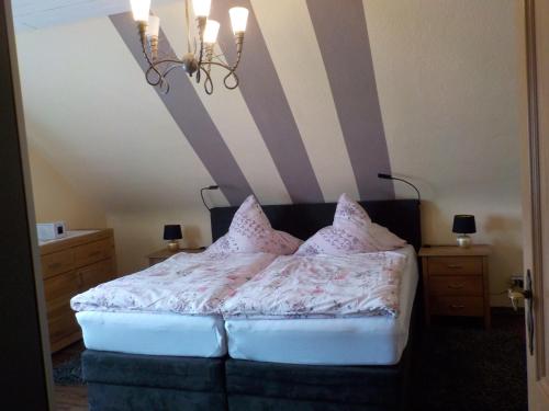 a bedroom with a bed with a striped wall at Ferienwohnung Wolf in Ensdorf