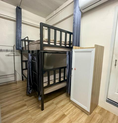 a room with two bunk beds and a door at Sweed Dee Hostel in Phi Phi Don