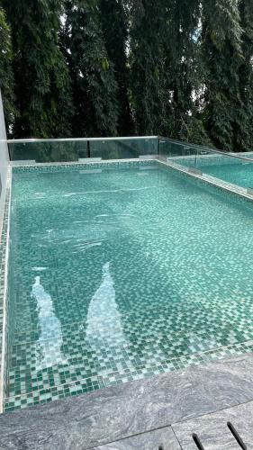 a swimming pool with a tiled floor and a swimming pool at Solaris Premium Luxury Living in Accra
